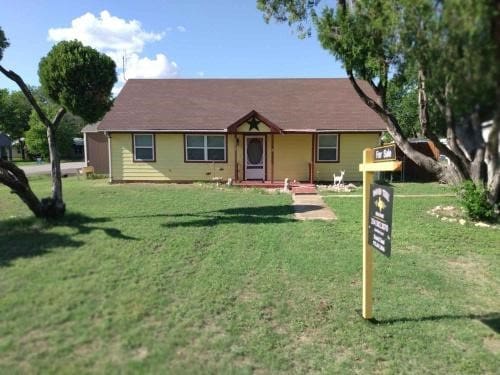 ranch-style house with a front lawn