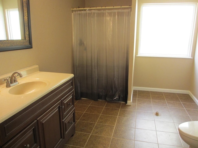 bathroom with vanity, curtained shower, toilet, baseboards, and tile patterned flooring