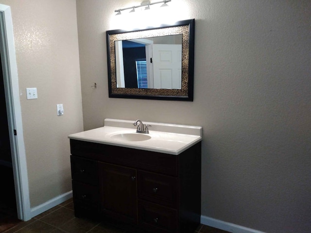 bathroom with tile patterned flooring, vanity, and baseboards