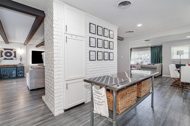 kitchen with open floor plan, visible vents, white cabinetry, and dark wood-style flooring