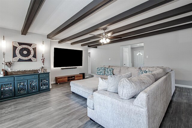 living room with beamed ceiling, baseboards, a ceiling fan, and wood finished floors