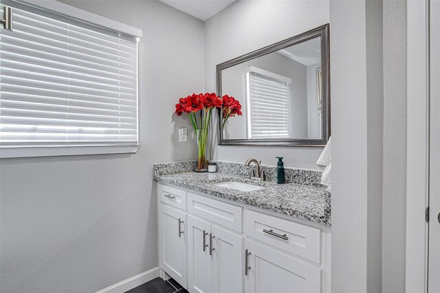 bathroom featuring baseboards, vanity, and tile patterned floors