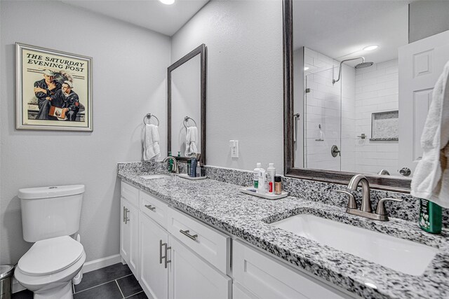 full bathroom featuring tiled shower, tile patterned floors, a sink, and toilet