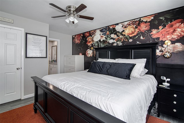 bedroom featuring baseboards, a ceiling fan, wood finished floors, and connected bathroom