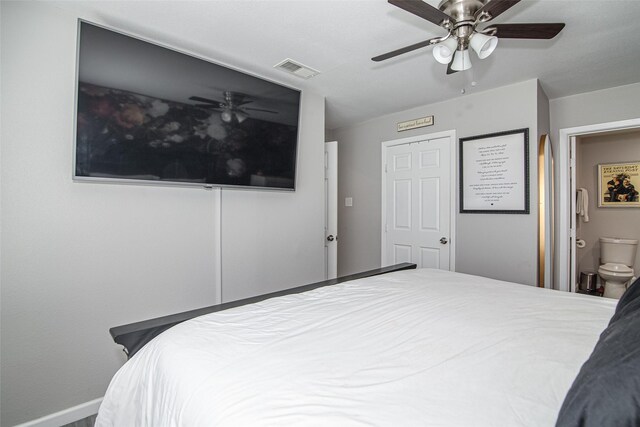 bedroom featuring baseboards, a ceiling fan, visible vents, and ensuite bathroom