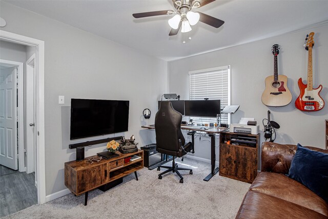 office area with ceiling fan, baseboards, and carpet