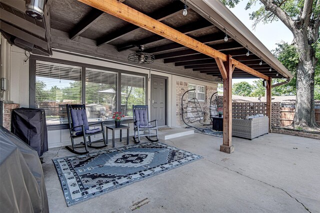 view of patio with fence and ceiling fan