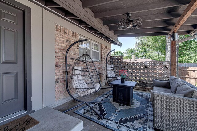view of patio / terrace featuring fence, ceiling fan, and an outdoor living space