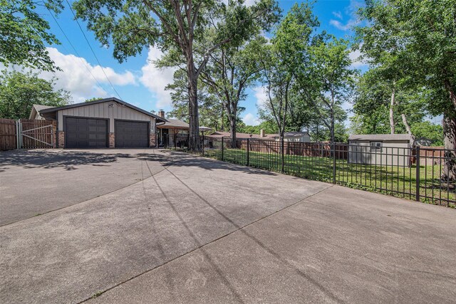 exterior space featuring a detached garage and fence