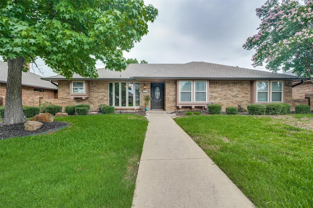 2307 Castle Rock Rd, Carrollton, TX 75007 - ranch-style home featuring brick siding, a front yard, and a shingled roof