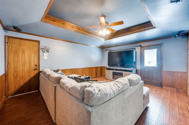 2307 Castle Rock Rd, Carrollton, TX 75007 - living room with a tray ceiling, a wainscoted wall, wooden walls, ceiling fan, and hardwood / wood-style flooring