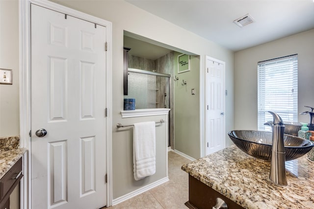2307 Castle Rock Rd, Carrollton, TX 75007 - full bath featuring vanity, a stall shower, tile patterned flooring, and baseboards