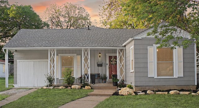 4024 Calmont Ave, Fort Worth, TX 76107 - ranch-style house with a porch, board and batten siding, a shingled roof, and a front yard