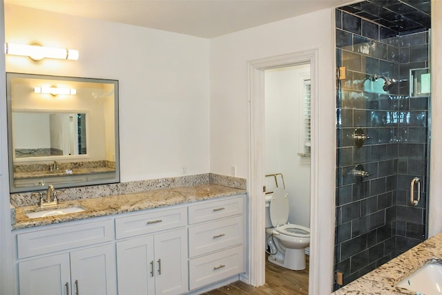 4024 Calmont Ave, Fort Worth, TX 76107 - full bath featuring a shower stall, toilet, vanity, and wood finished floors