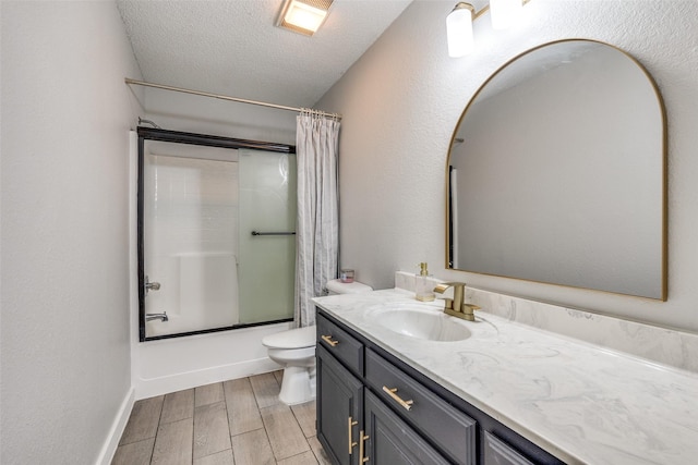 full bathroom featuring a textured ceiling, toilet, shower / tub combo with curtain, wood finished floors, and vanity