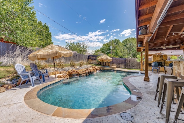 view of swimming pool featuring a fenced backyard, ceiling fan, a patio, and a pool with connected hot tub