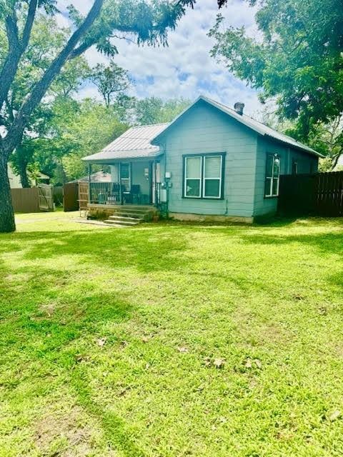 715 W Ball St, Weatherford, TX 76086 - rear view of property featuring a metal roof and a porch