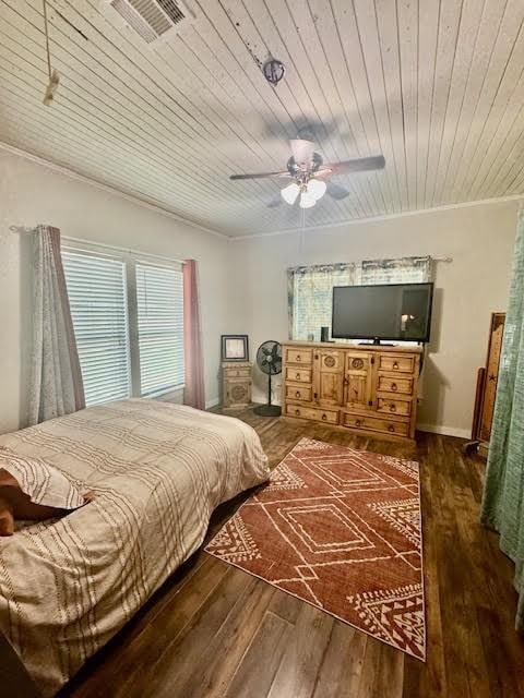 715 W Ball St, Weatherford, TX 76086 - bedroom featuring ornamental molding, wood finished floors, wooden ceiling, and ceiling fan