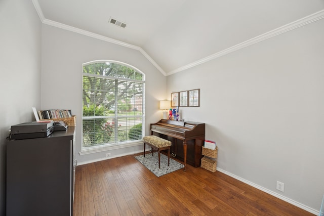 office featuring baseboards, visible vents, wood finished floors, and ornamental molding