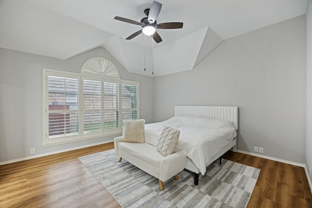 bedroom with lofted ceiling, wood finished floors, ceiling fan, and baseboards