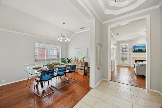 foyer entrance featuring hardwood / wood-style flooring, crown molding, and a chandelier
