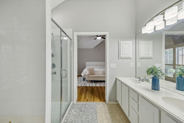 ensuite bathroom featuring a stall shower, ceiling fan, double vanity, and ensuite bathroom