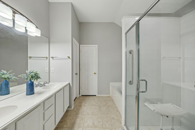 bathroom featuring a stall shower, tile patterned flooring, a sink, and a bath