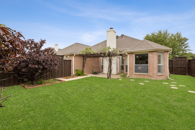 back of property with a chimney, a fenced backyard, brick siding, a patio area, and a pergola