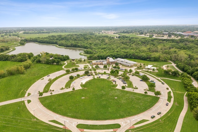 birds eye view of property featuring a water view and a view of trees