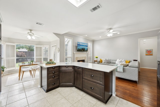kitchen featuring open floor plan, visible vents, and a ceiling fan