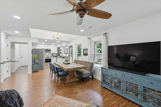 dining area featuring visible vents, baseboards, ceiling fan with notable chandelier, light wood finished floors, and recessed lighting