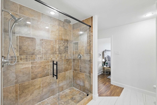 bathroom with baseboards, a stall shower, and recessed lighting