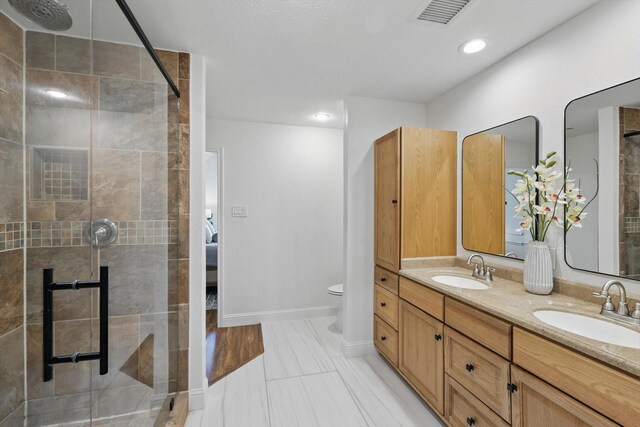 1457 Woodlawn Ct, Keller, TX 76262 - bathroom with a stall shower, double vanity, toilet, and baseboards