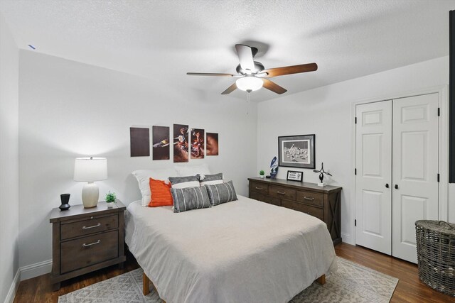 1457 Woodlawn Ct, Keller, TX 76262 - bedroom featuring dark wood-style floors, baseboards, a closet, a ceiling fan, and a textured ceiling