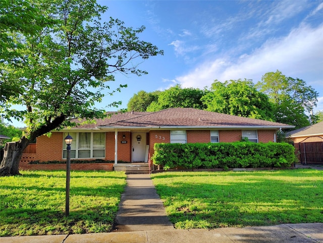 ranch-style home with a front lawn and brick siding