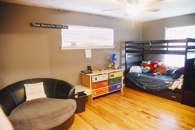 bedroom featuring multiple windows and light wood-style floors