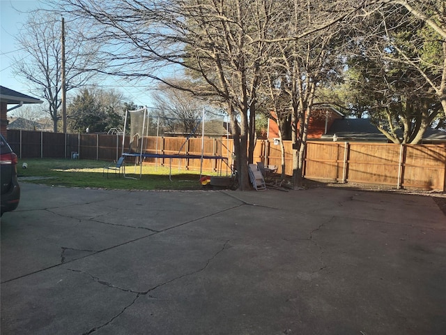 view of patio / terrace featuring a fenced backyard and a trampoline