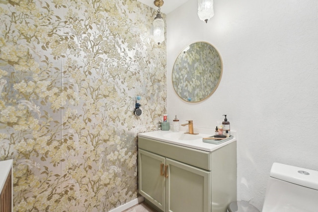 half bathroom with toilet and vanity