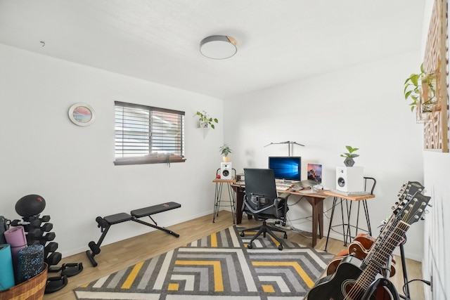 home office featuring baseboards and wood finished floors