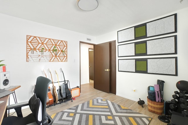 home office featuring baseboards and wood finished floors