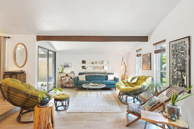 living room with vaulted ceiling with beams and light wood-style floors