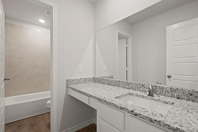 2433 Dahlia Dr, Fort Worth, TX 76123 - full bathroom with wood finished floors, toilet, vanity, recessed lighting, and shower / tub combination