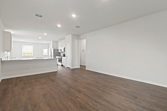 2433 Dahlia Dr, Fort Worth, TX 76123 - unfurnished living room featuring dark wood finished floors, baseboards, recessed lighting, and a sink