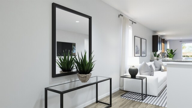 interior space featuring baseboards, recessed lighting, and light wood-style floors