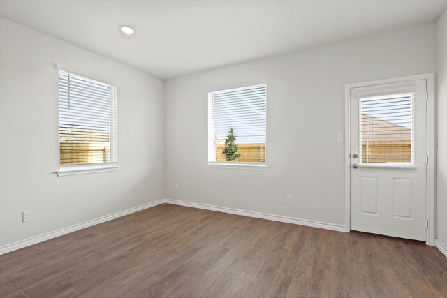 2433 Dahlia Dr, Fort Worth, TX 76123 - spare room with healthy amount of natural light, dark wood-style flooring, baseboards, and recessed lighting