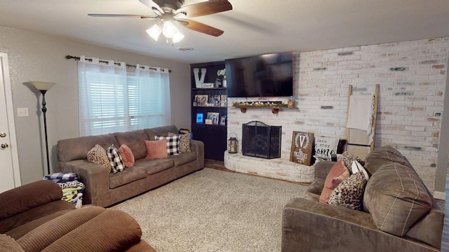 living room featuring a brick fireplace and ceiling fan