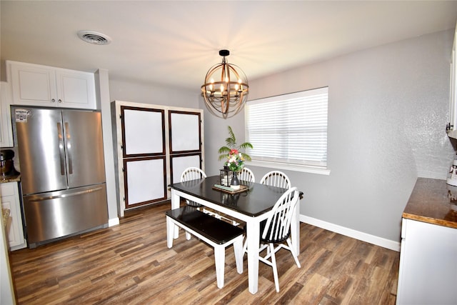 dining area with visible vents, baseboards, a chandelier, and dark wood-type flooring