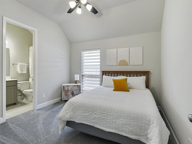 home office featuring vaulted ceiling, baseboards, and light carpet