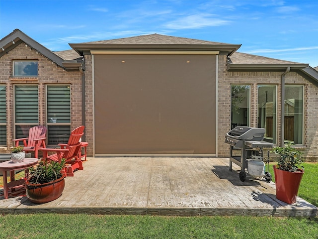 8901 Brandy Branch Way, Mckinney, TX 75071 - rear view of property featuring brick siding, roof with shingles, and a patio area