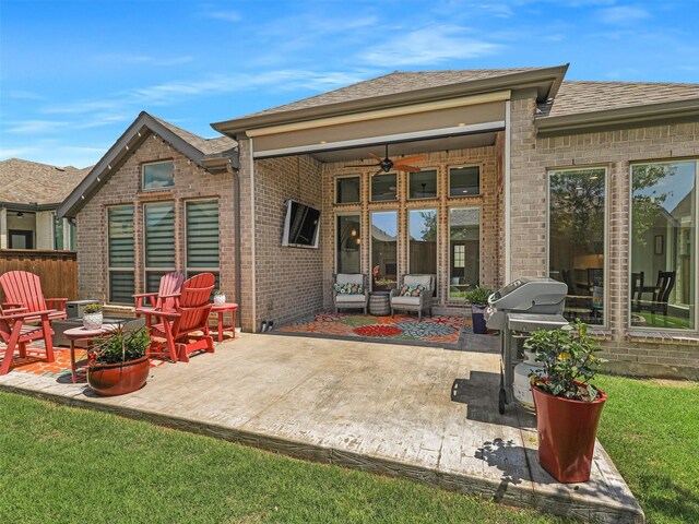 rear view of property with ceiling fan, brick siding, roof with shingles, and a patio